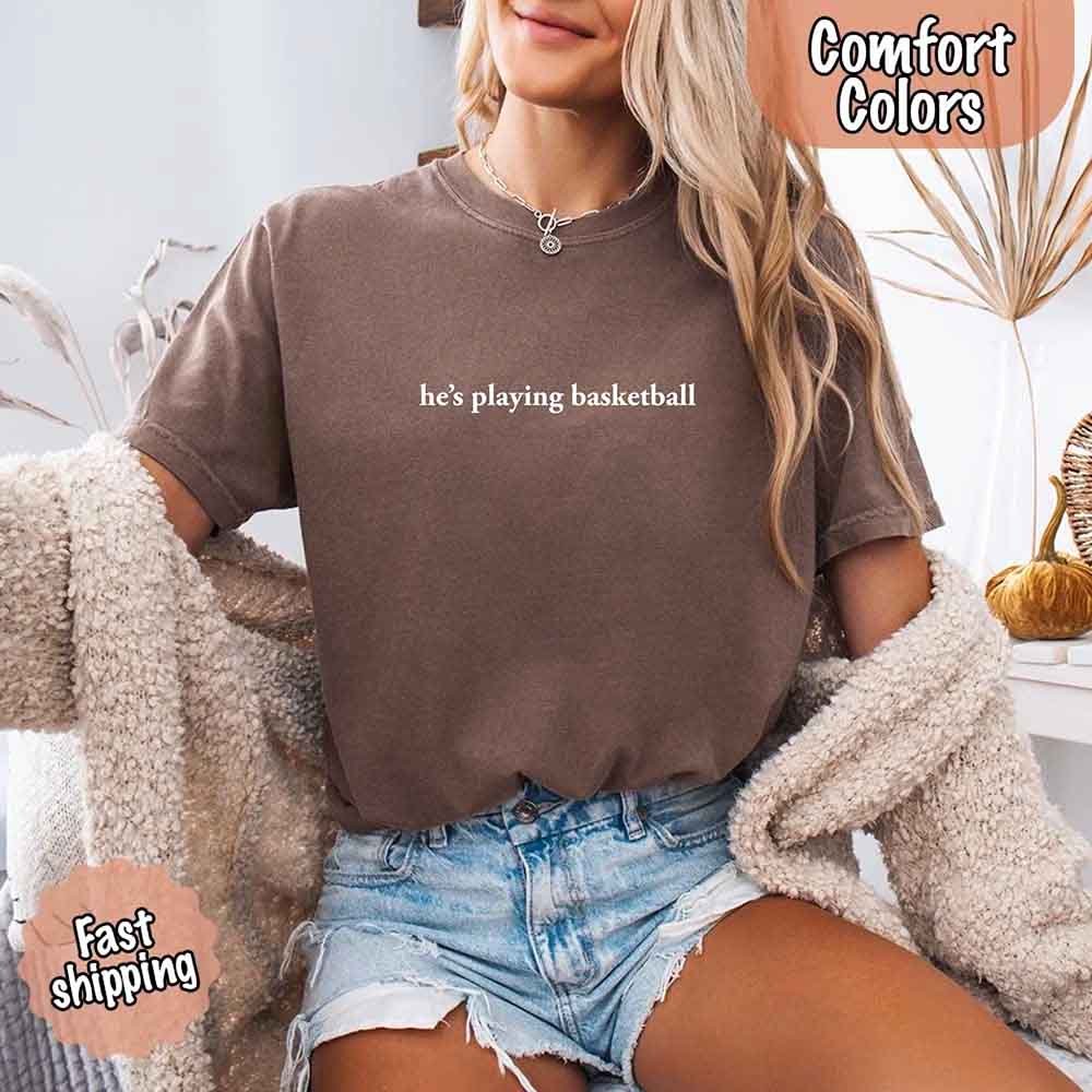 He’s Playing Basketball – Funny Sports Girlfriend Comfort Colors Shirt for Women