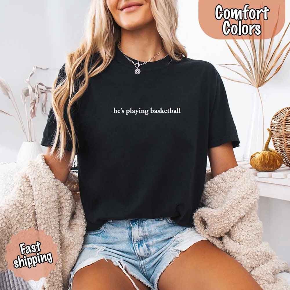 He’s Playing Basketball – Funny Sports Girlfriend Comfort Colors Shirt for Women