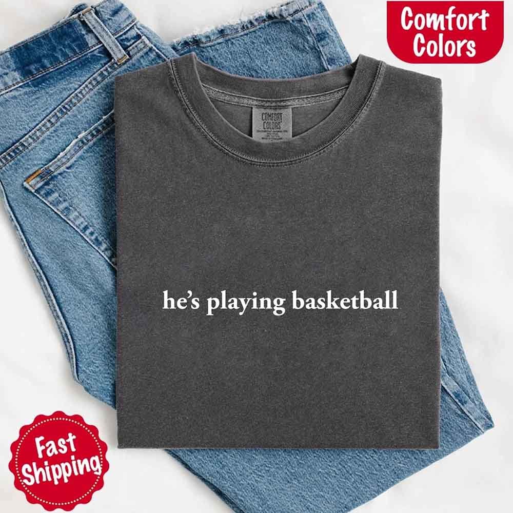 He’s Playing Basketball – Funny Sports Girlfriend Comfort Colors Shirt for Women