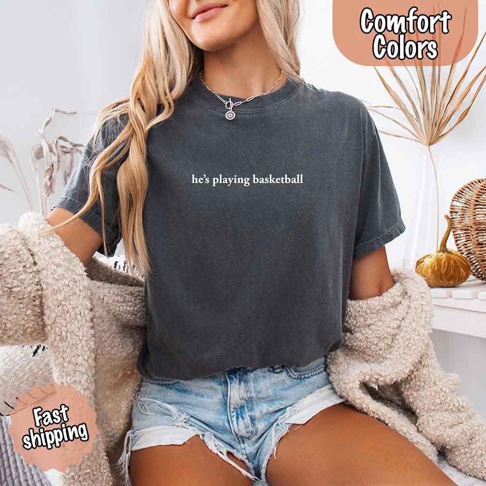 He’s Playing Basketball – Funny Sports Girlfriend Comfort Colors Shirt for Women