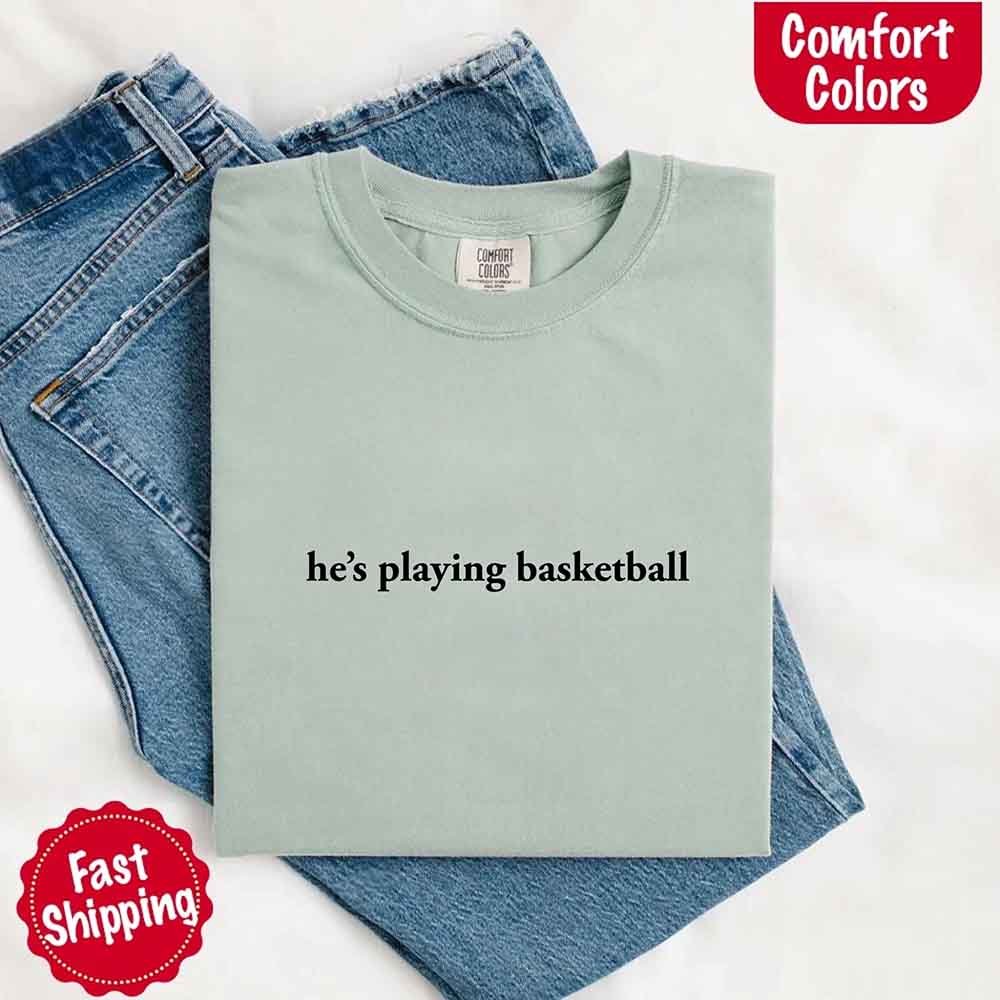 He’s Playing Basketball – Funny Sports Girlfriend Comfort Colors Shirt for Women
